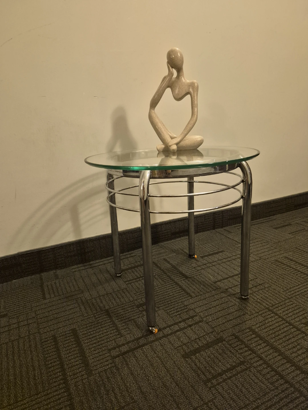 Glass top side table with silver legs and wheels - photo 3