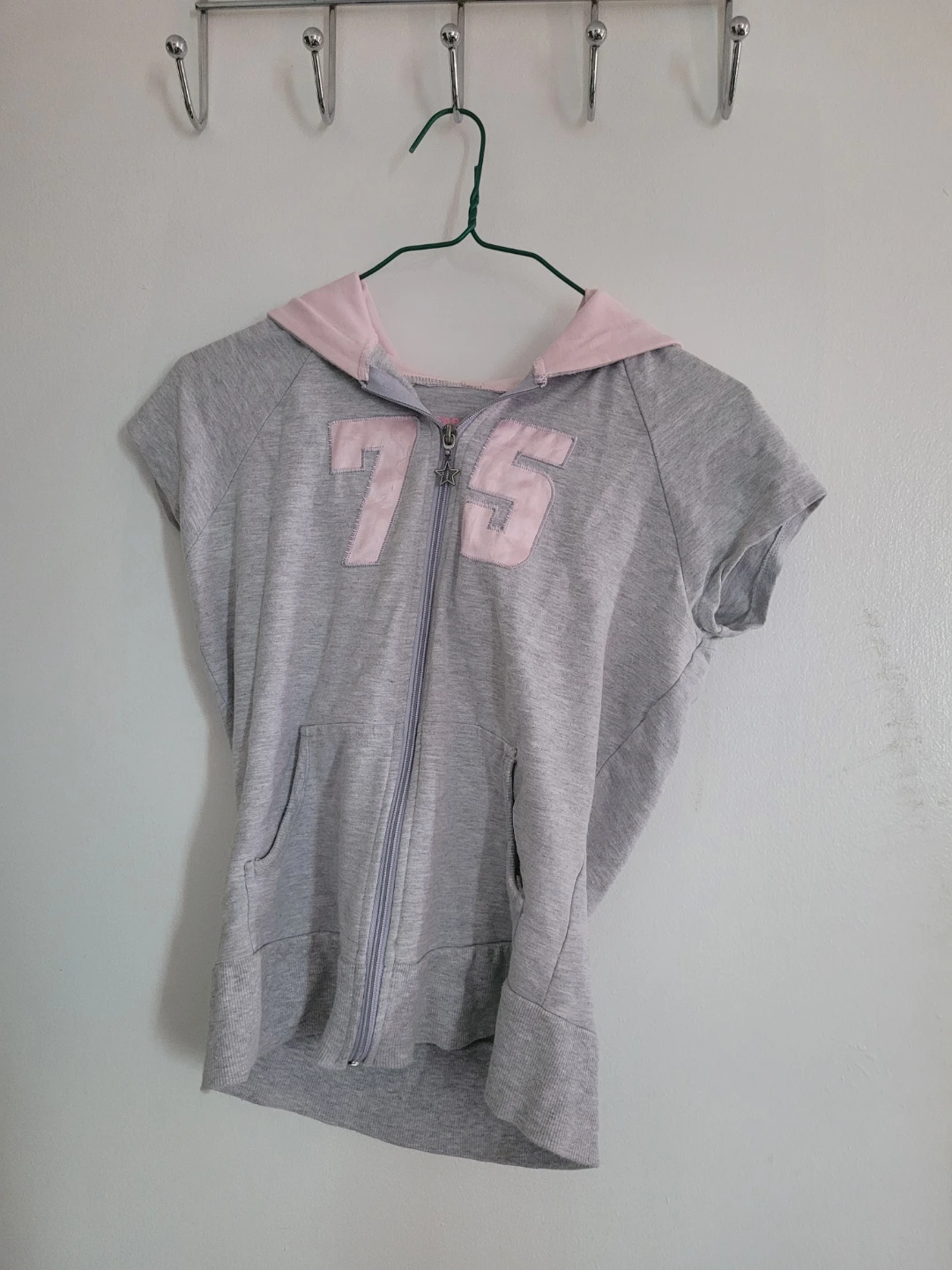 Grey zip-up hoodie with pink trim and number 75