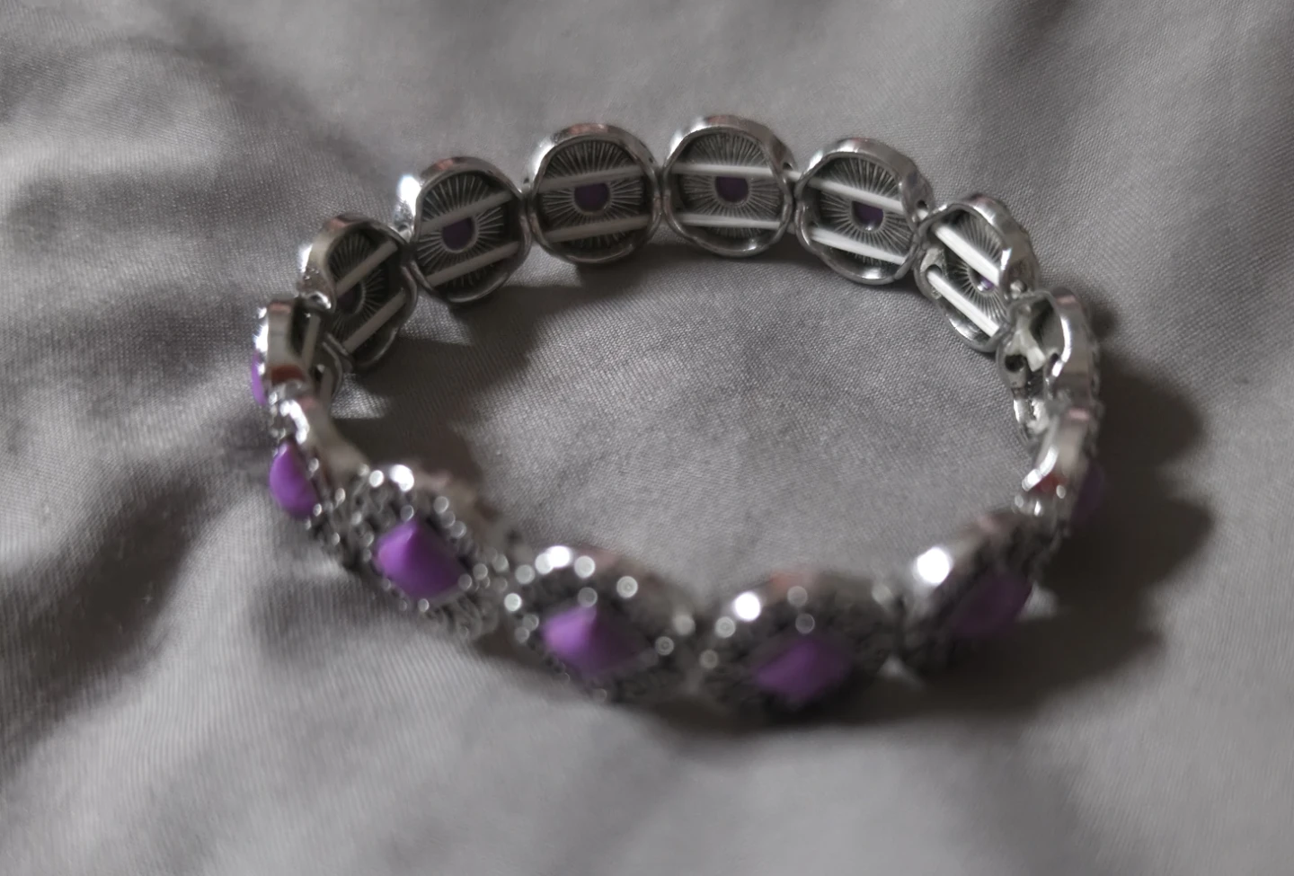 Silver tone bracelet with purple gems