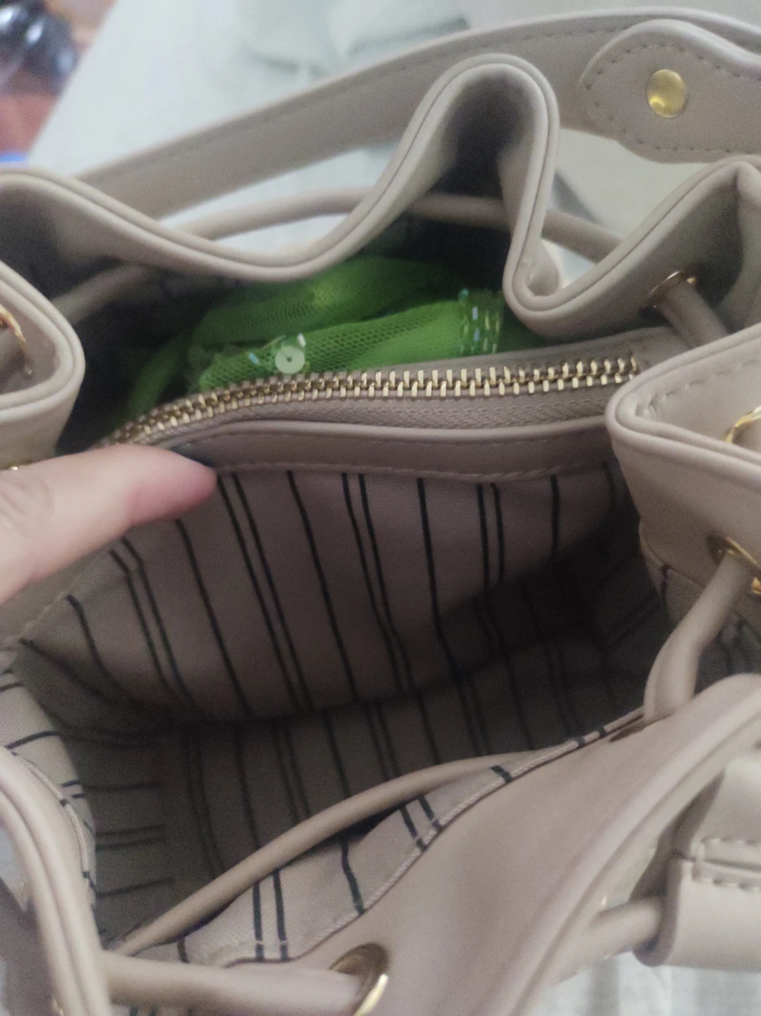 Beige bucket bag with gold accents