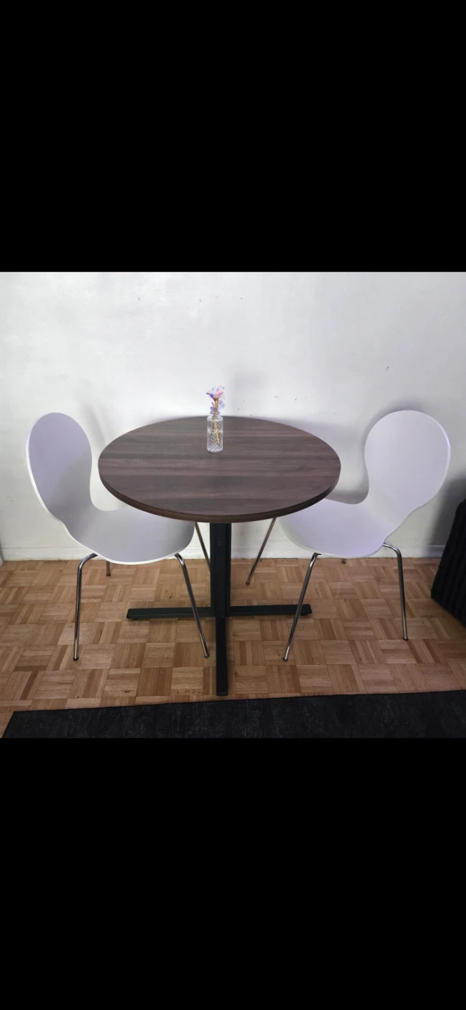 Table and two chairs .