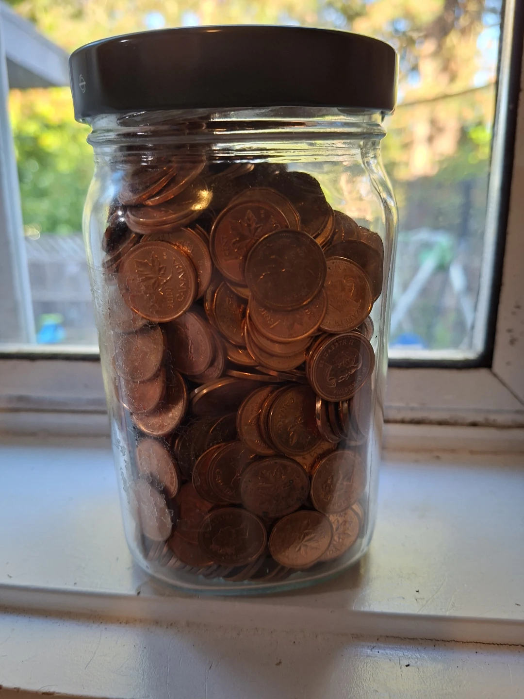 Glass pickle jar full of pennies - photo 4