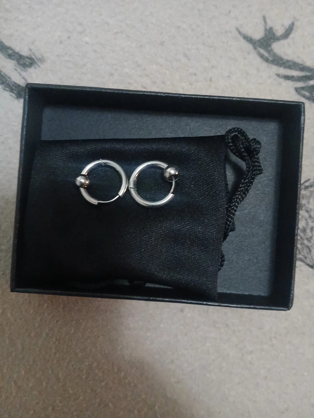 Silver hoop earrings with ball accent