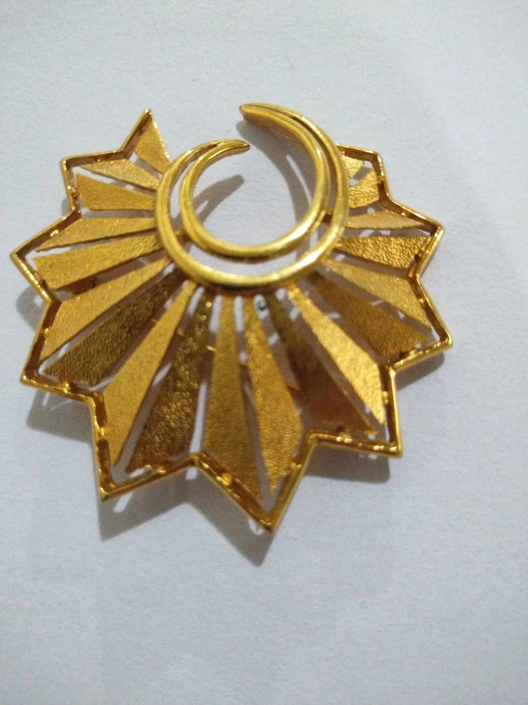Trifaria textured and polished gold tone pointed swirl brooch