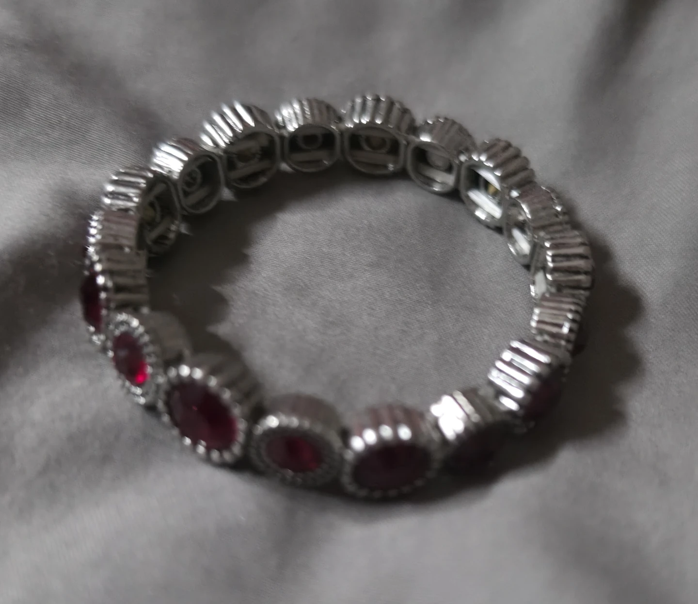 Silver tone bracelet with red stones