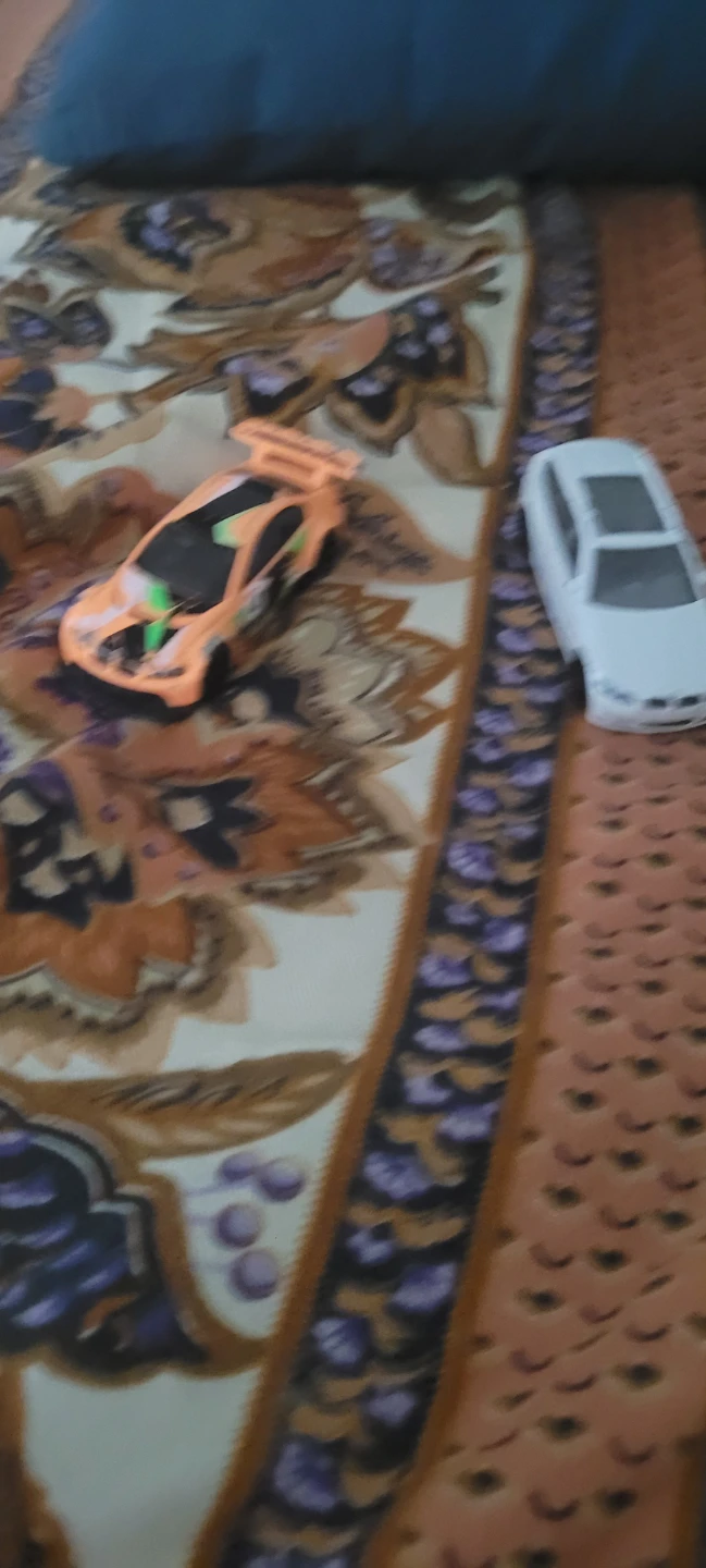Orange toy race car and white toy car