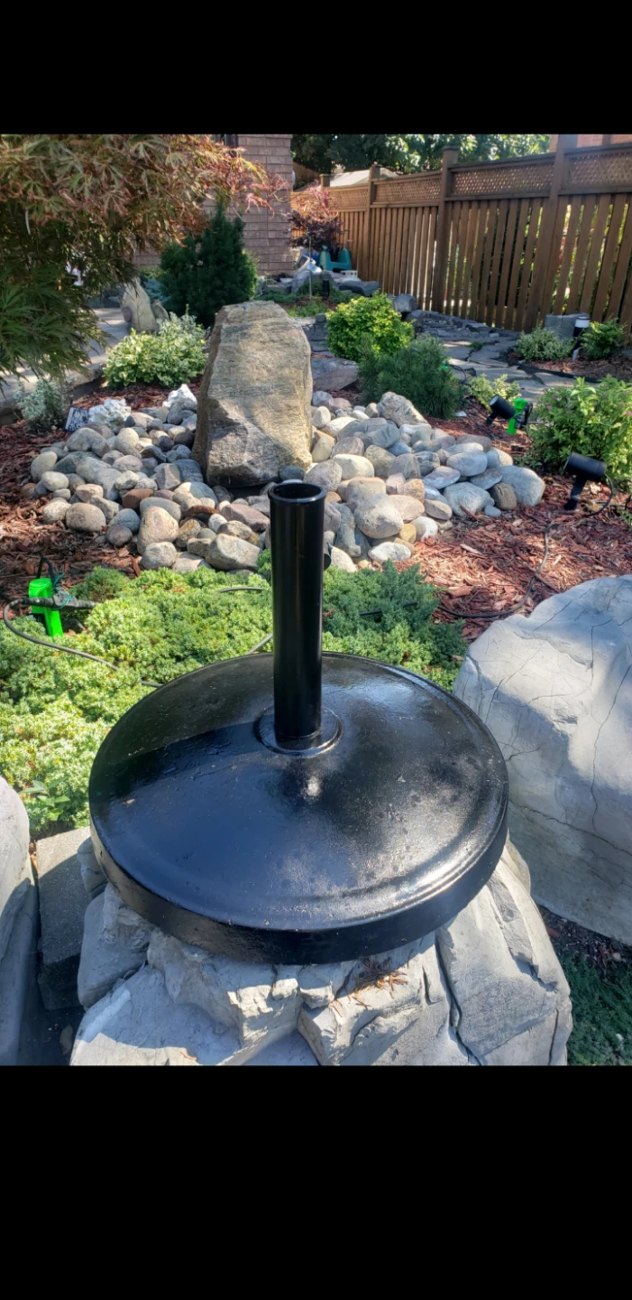 Black patio umbrella stand concrete