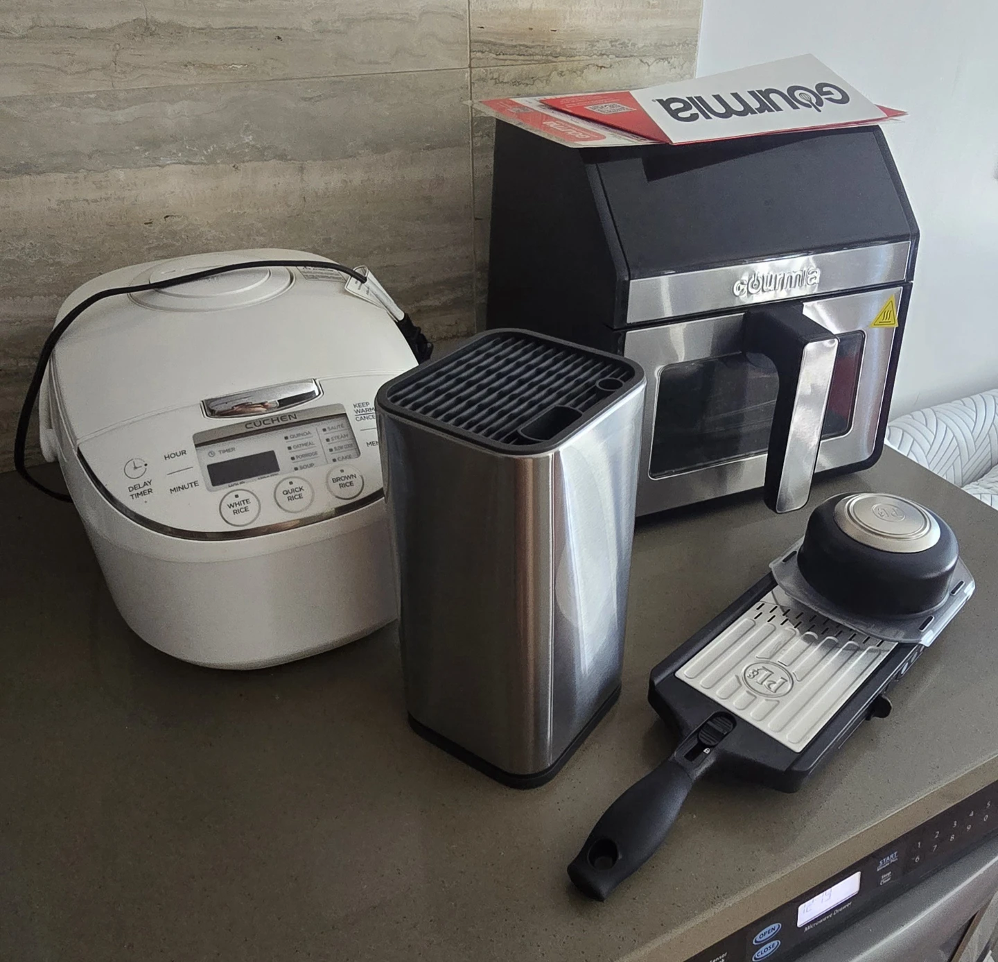 Air Fryer, rice cooker, knife block, and a mandoline slicer.