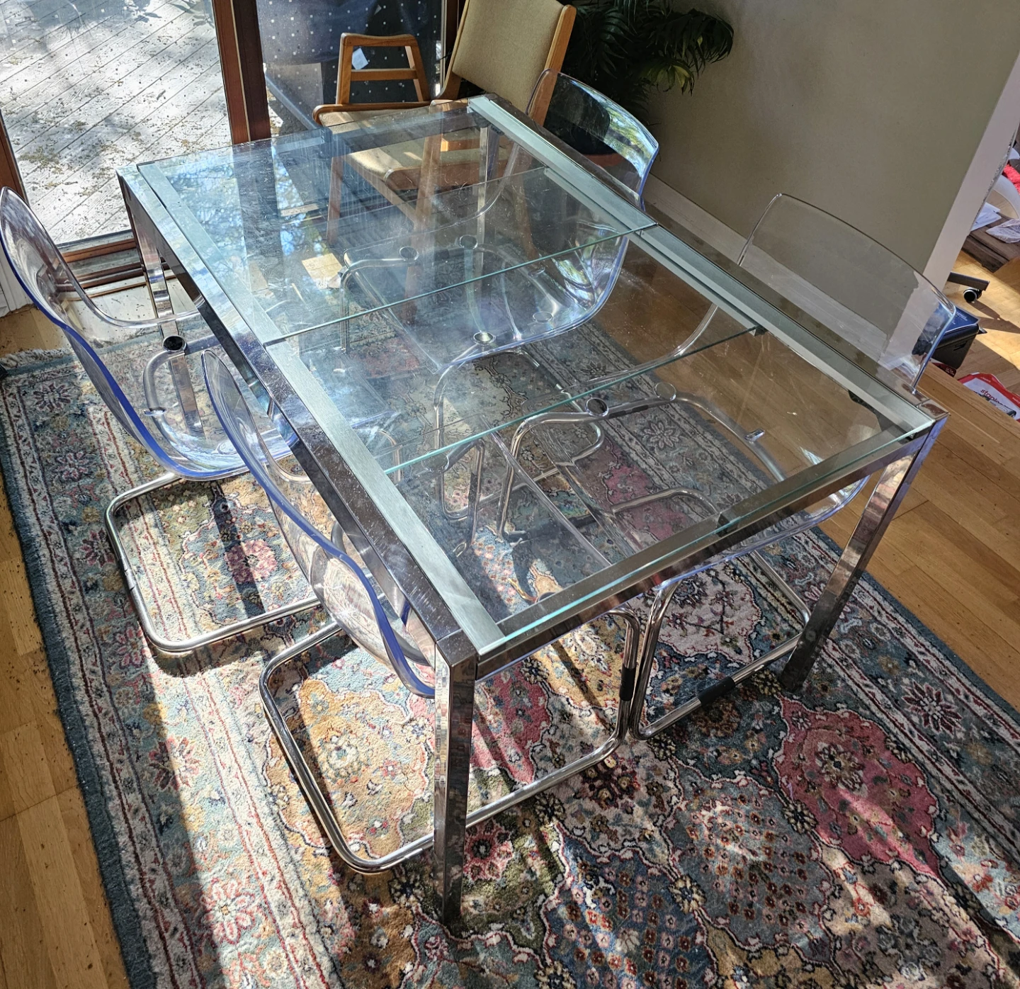 Glass top IKEA dining table with 4 plastic chairs