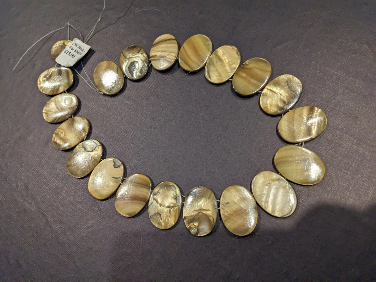 Double drilled golden brown shell beads
