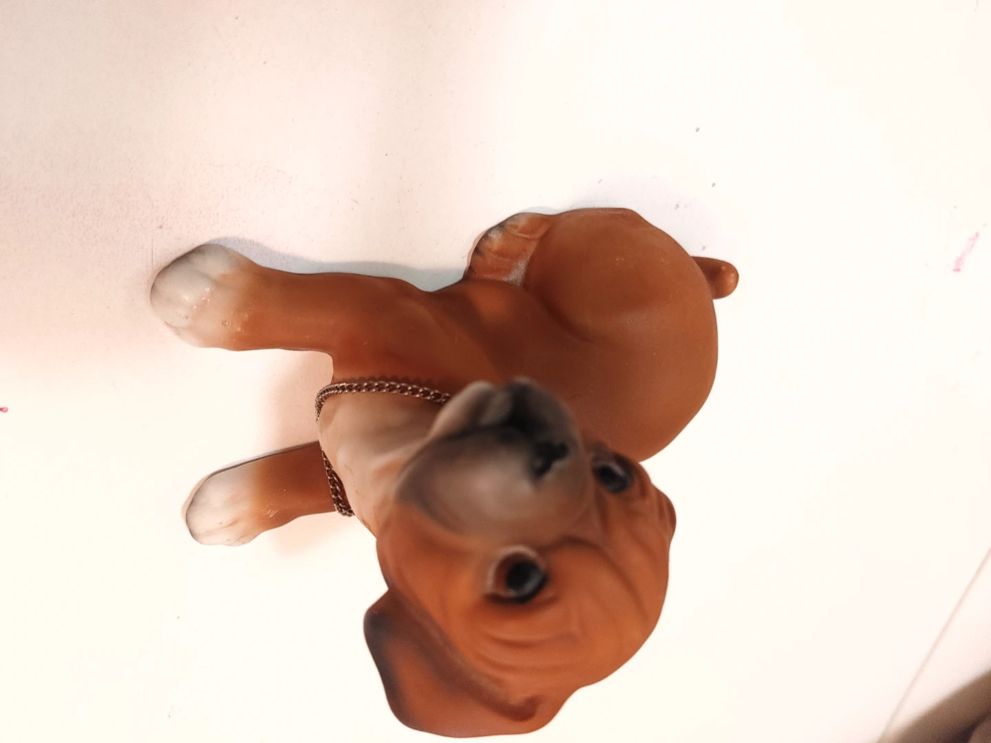 Brown dog figurine with chain