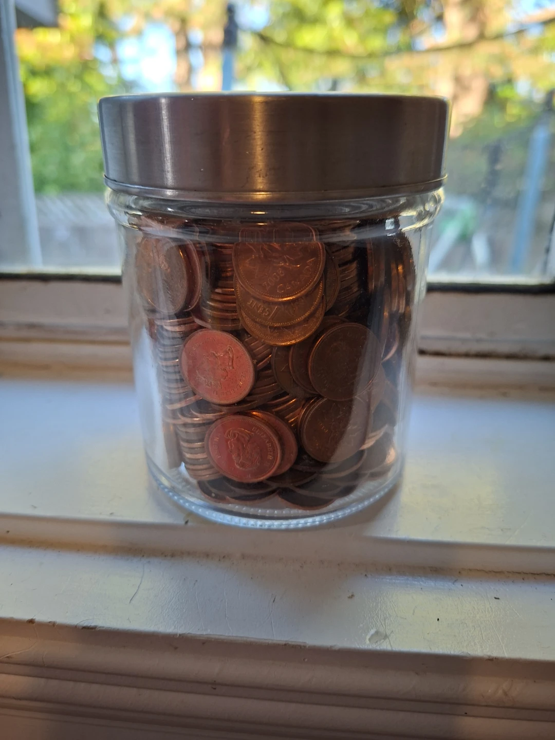 Glass Jar with Metal Lid filled with Pennies