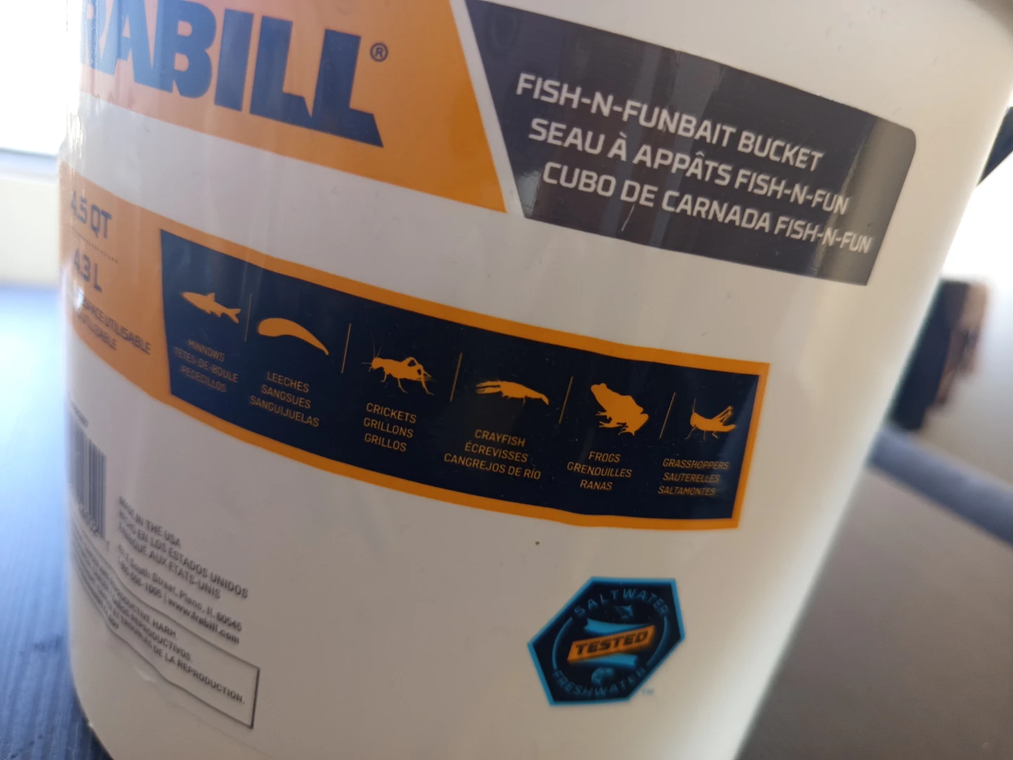 Frabill fishing bucket for sale, including a few fishing lures.