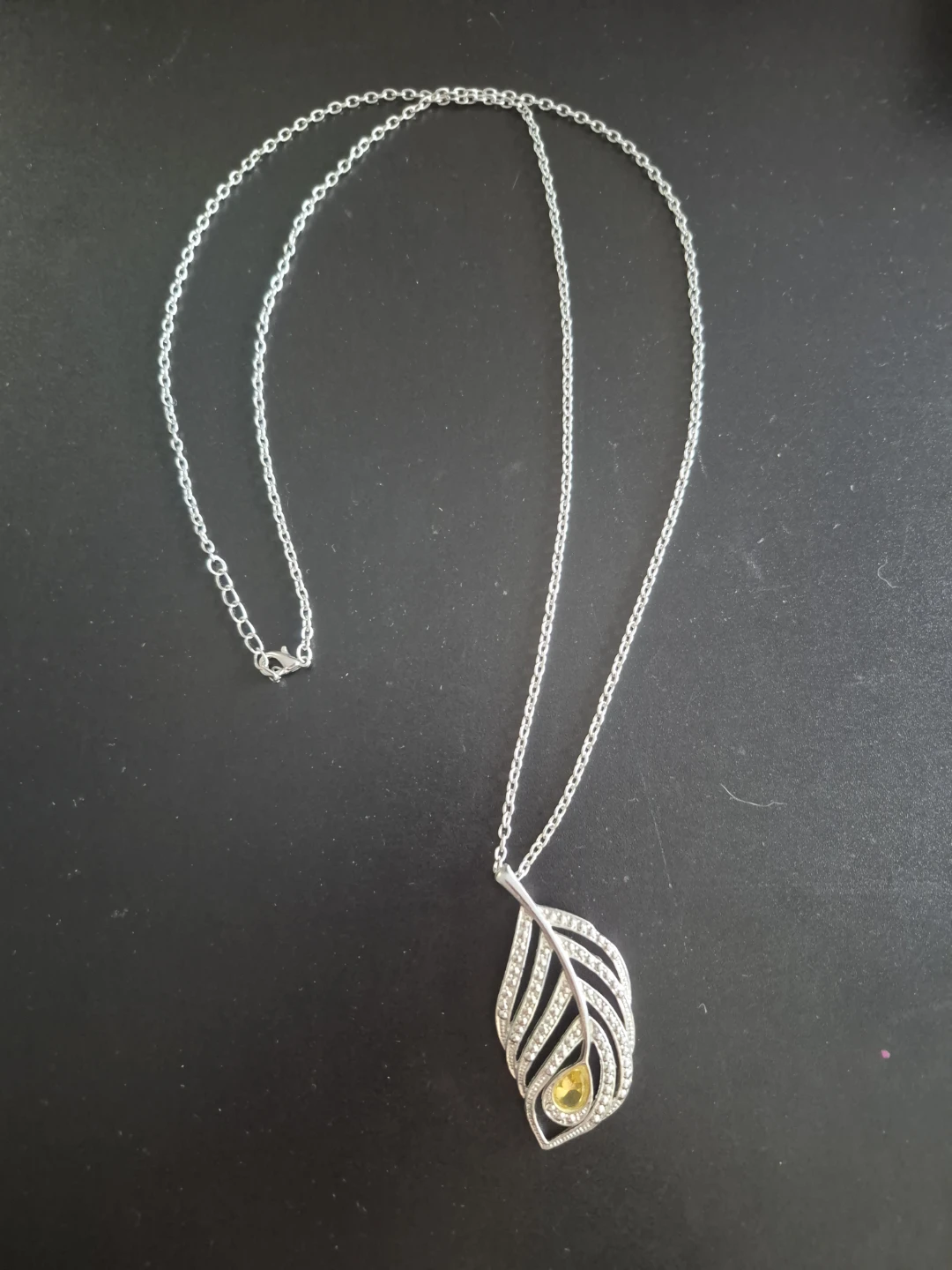 Feather pendant necklace with yellow accent