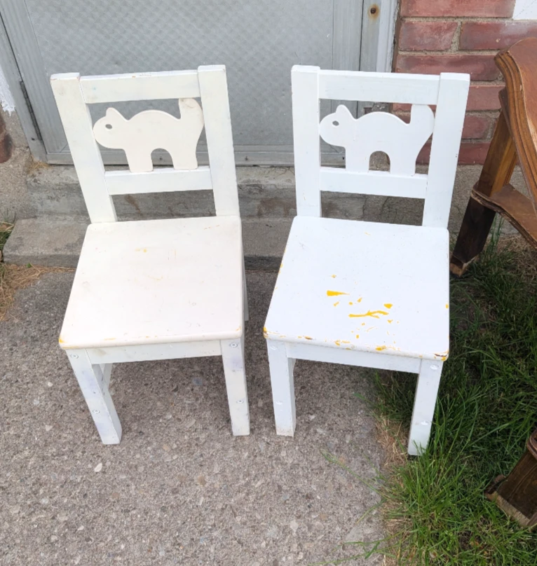 One white wooden kids chairs with cat backs