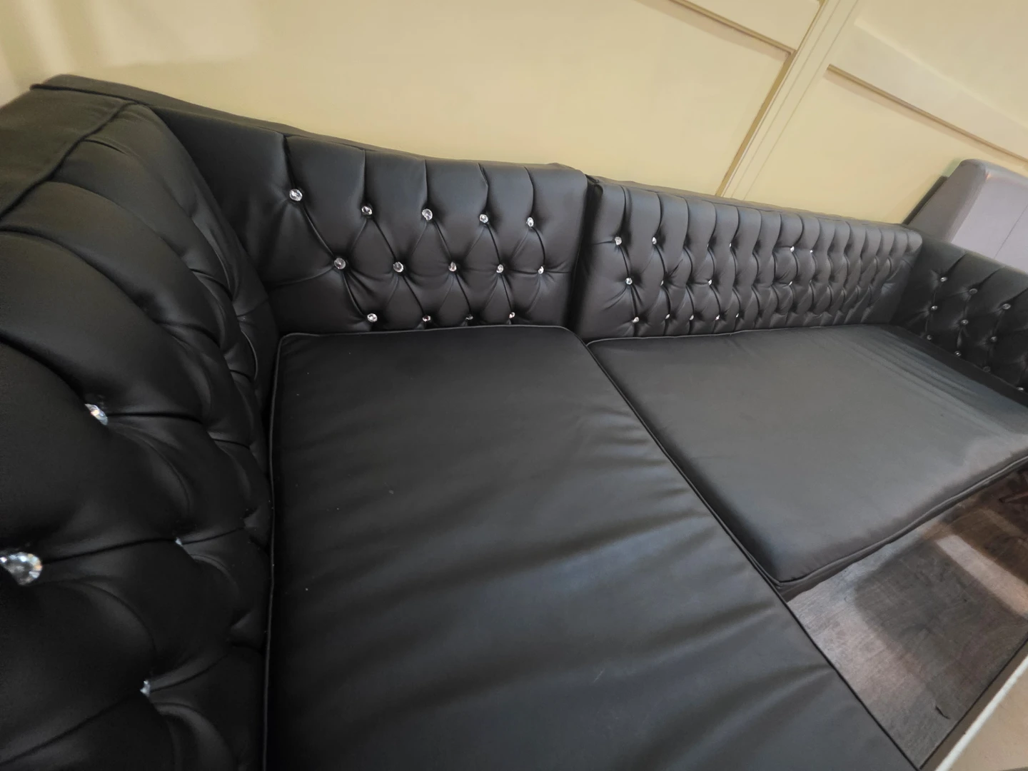 Black Tufted Sofa with Crystal Accents