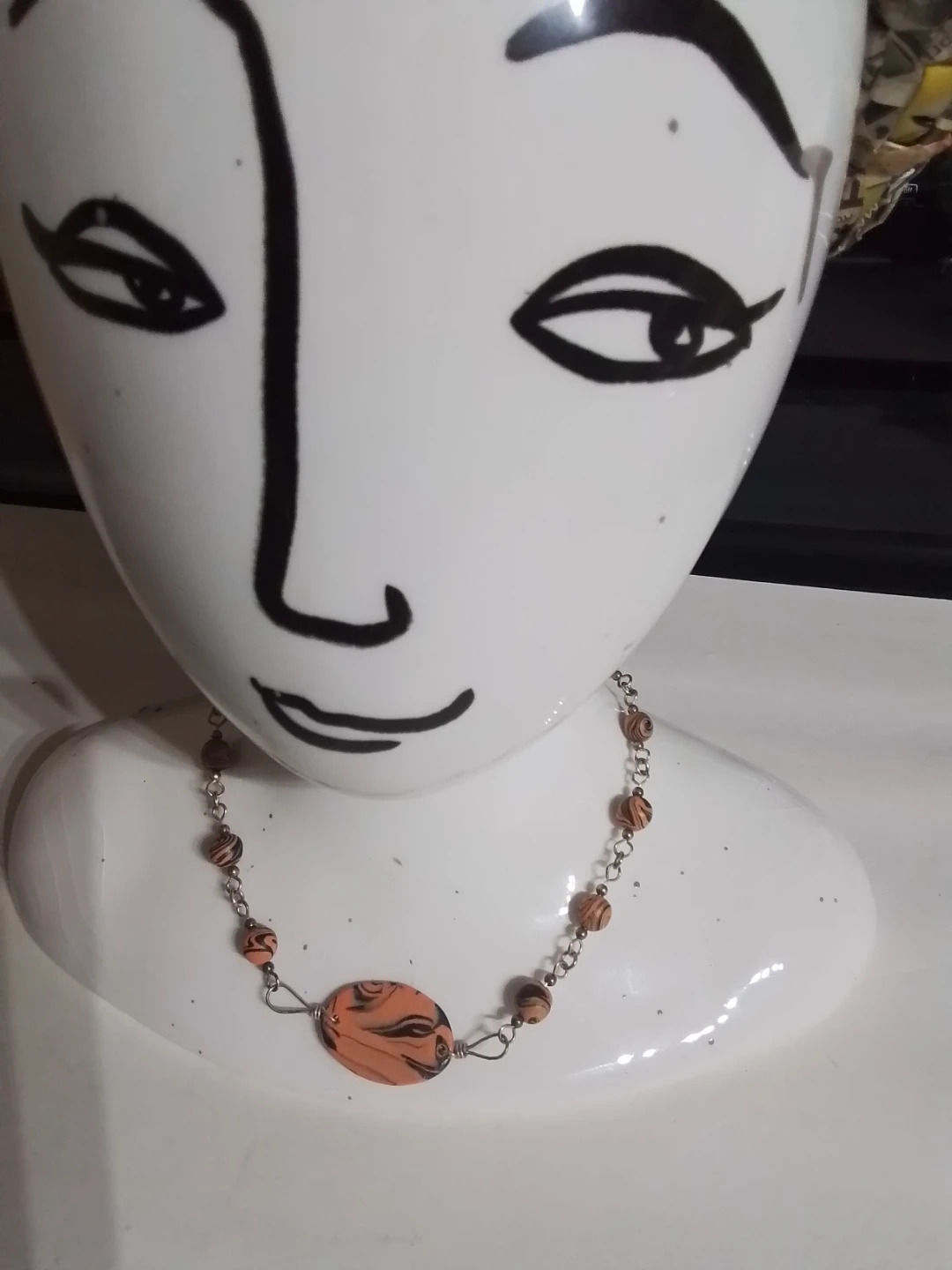 Orange and black swirl bead necklace