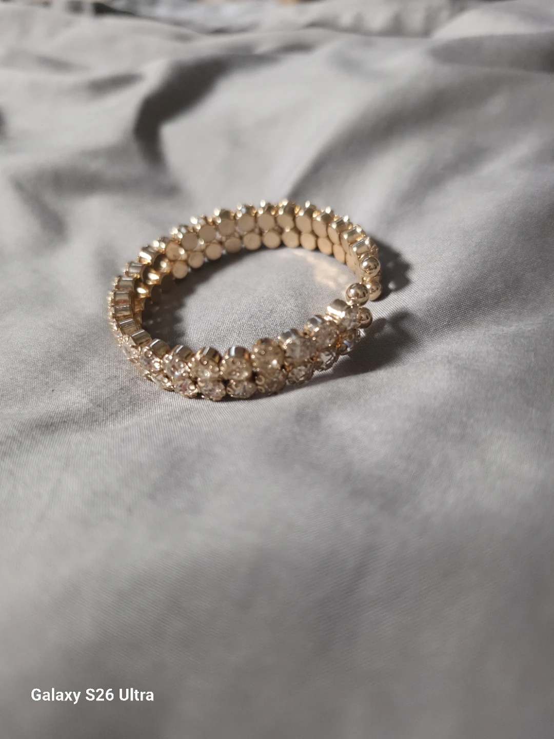 Gold tone stretch bracelet with rhinestones