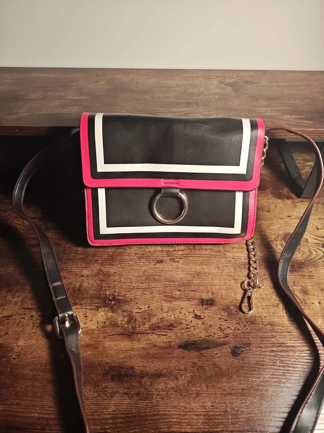 Black crossbody purse with pink and white trim
