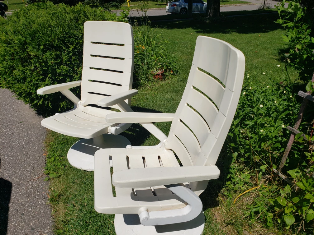 Two Plastic Swivel Patio Chairs