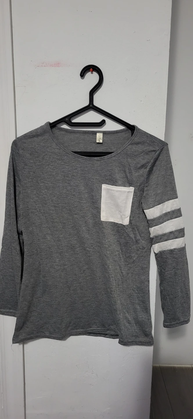 Grey long-sleeve shirt with white pocket and striped sleeves