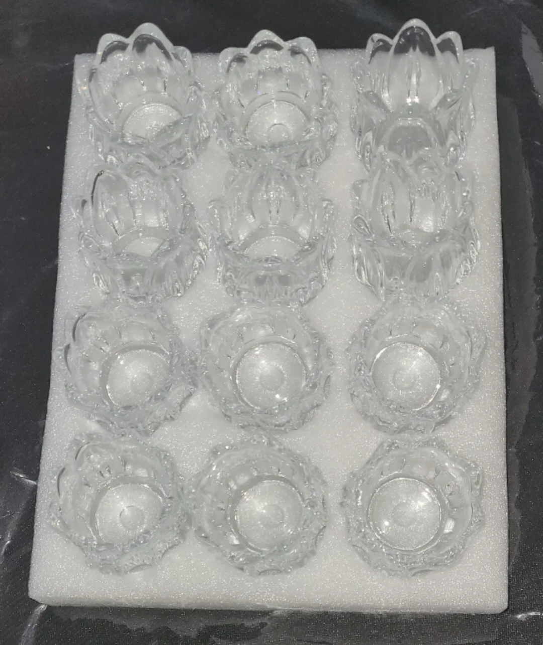 Set of 24 Clear tea light holders.