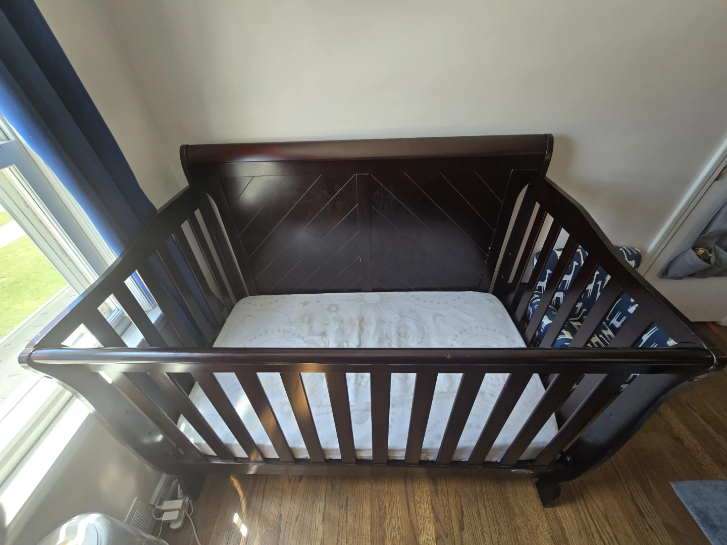 Dark Wood Baby Crib and armchair