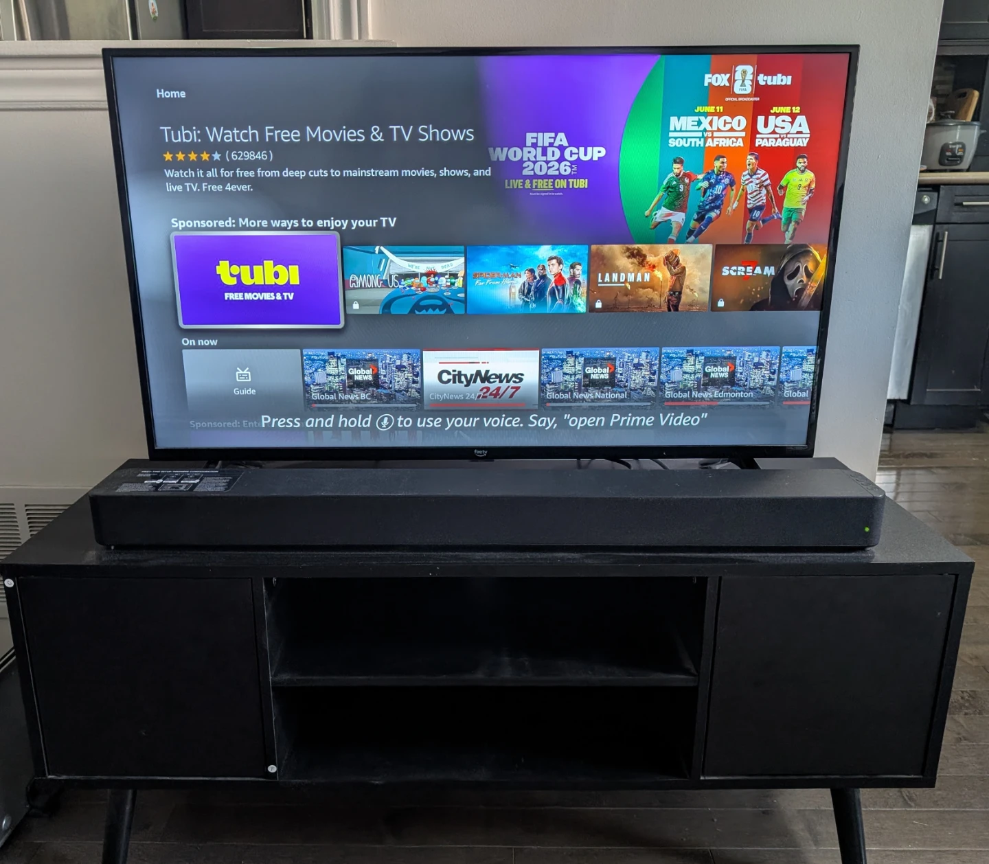 Amazon Fire TV with Soundbar and TV stand.