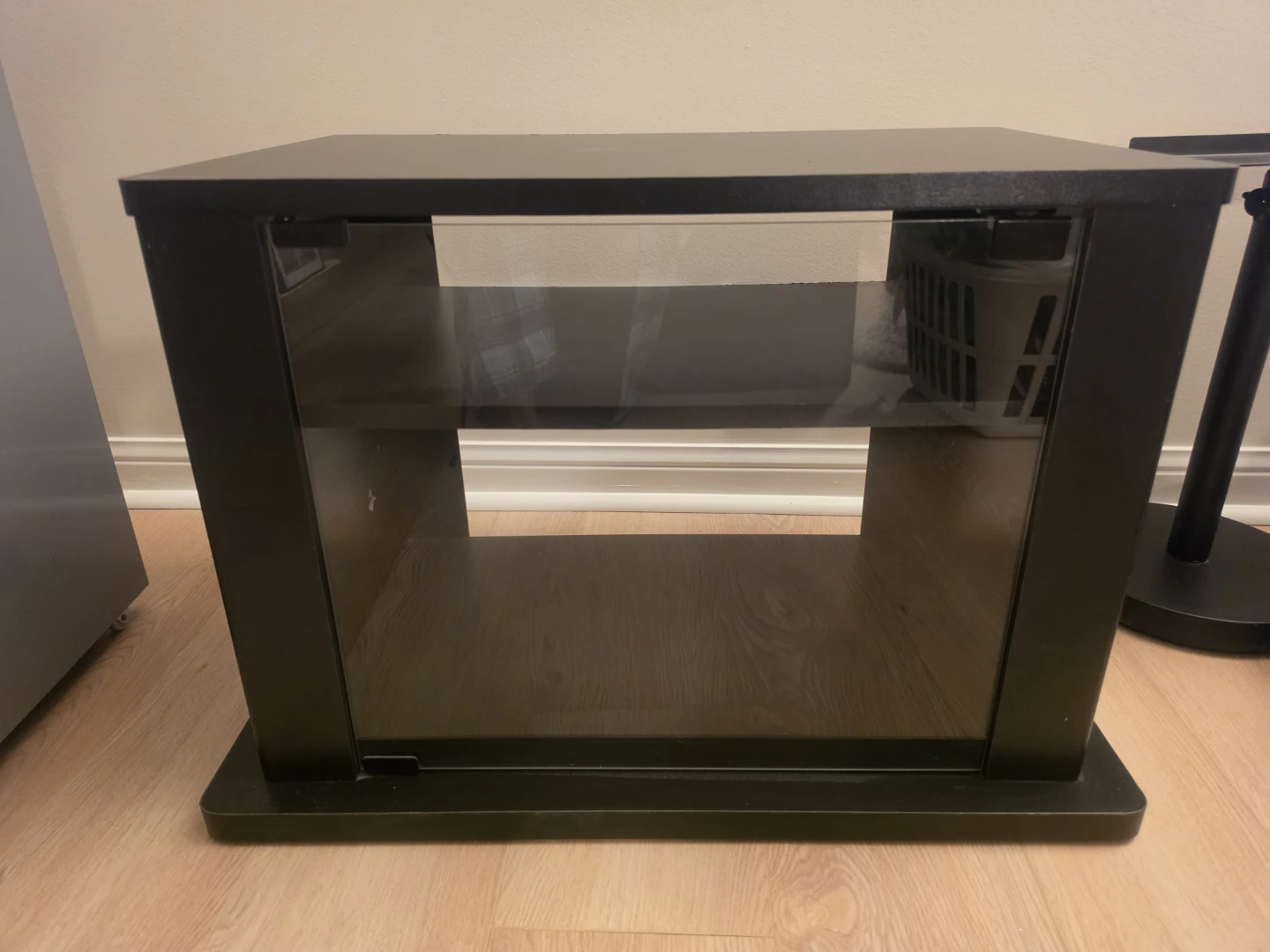 Black TV stand with glass door and storage