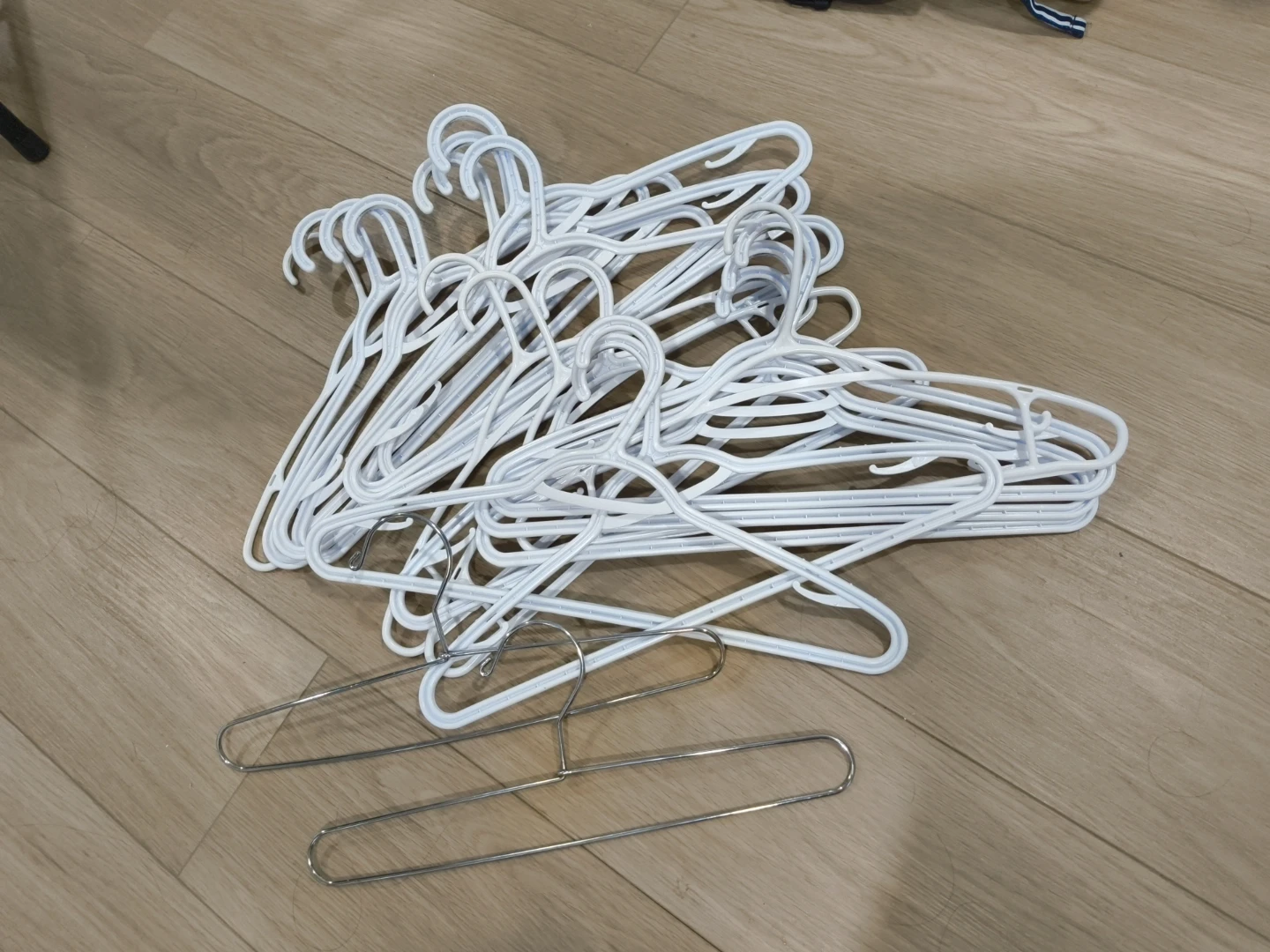 Bundle of White Plastic and Metal Hangers