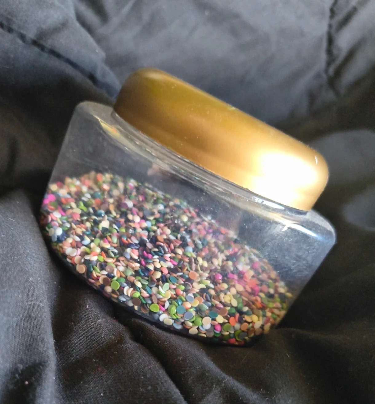 Plastic jar of colourful diamond painting beads
