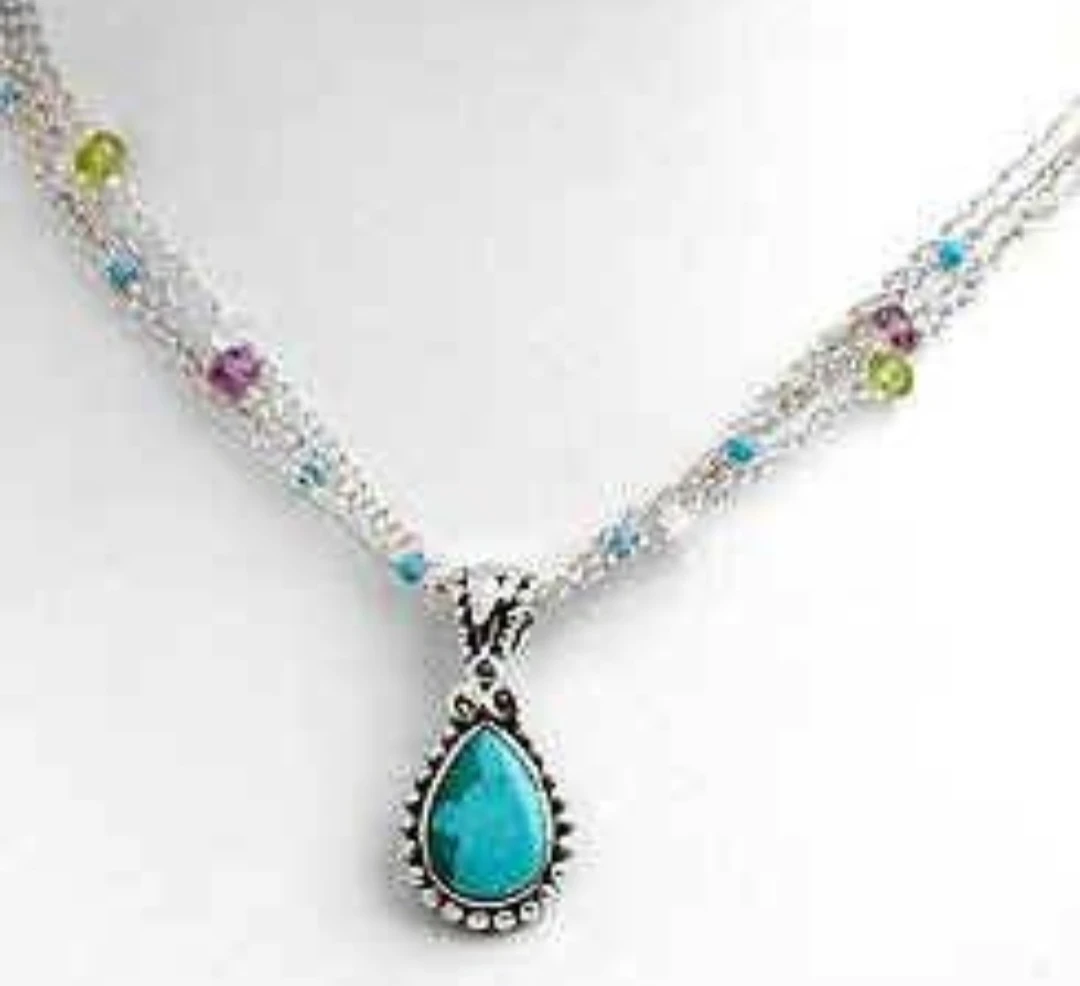 Necklace. Turquoise pendant on multiple silver chains and gems