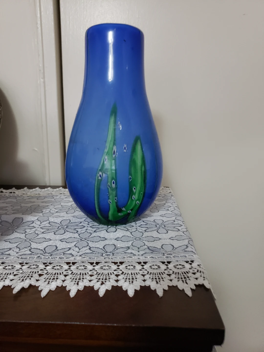 Blue glass vase with green floral design