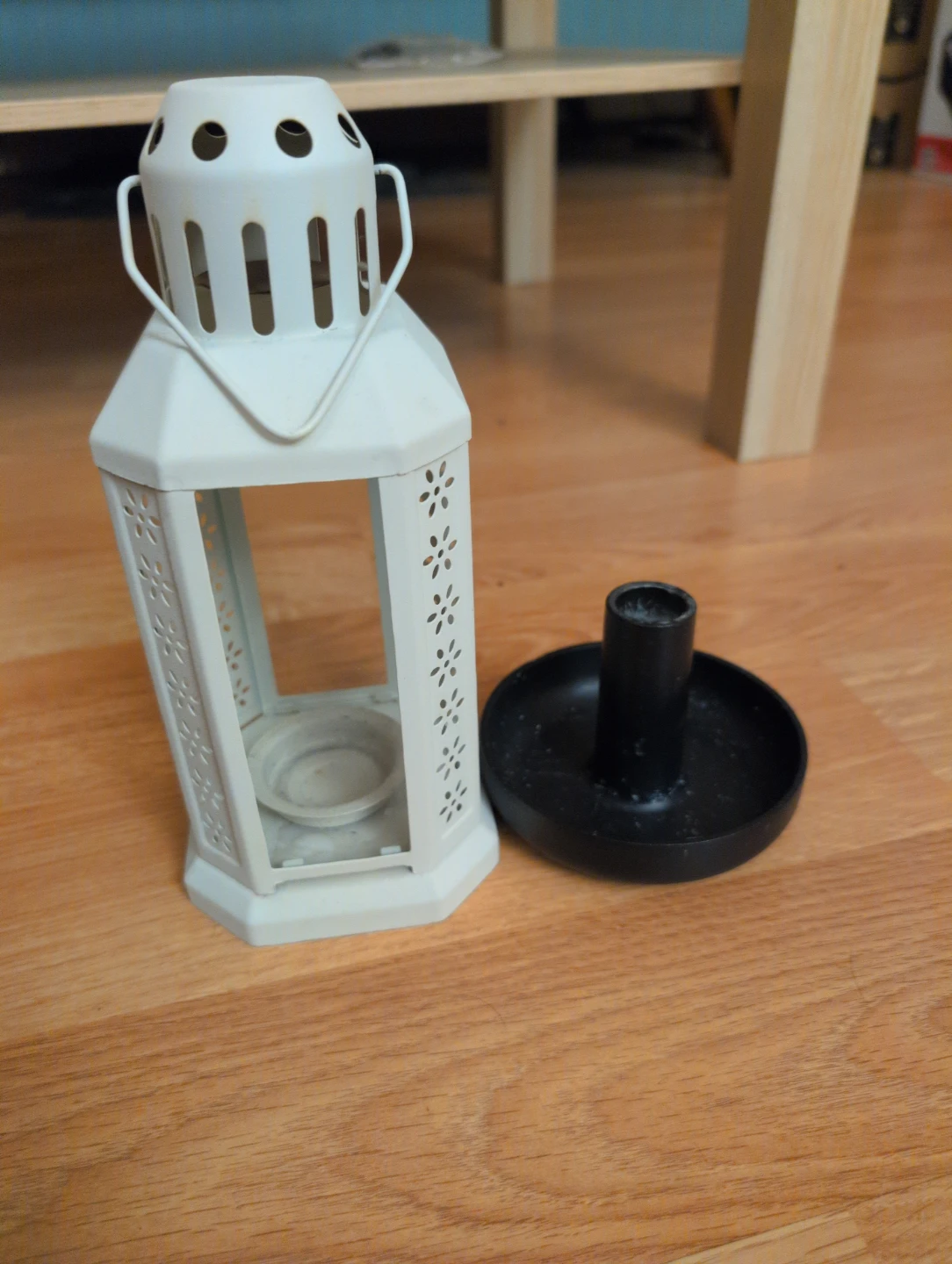 White decorative lantern with black candle holder