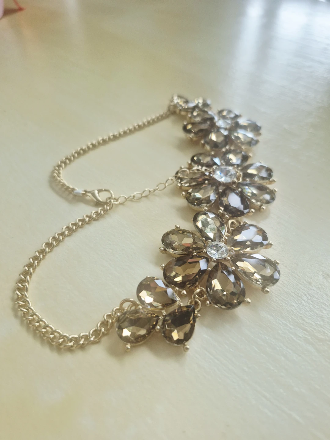 Gold-tone statement necklace with floral crystal pendants