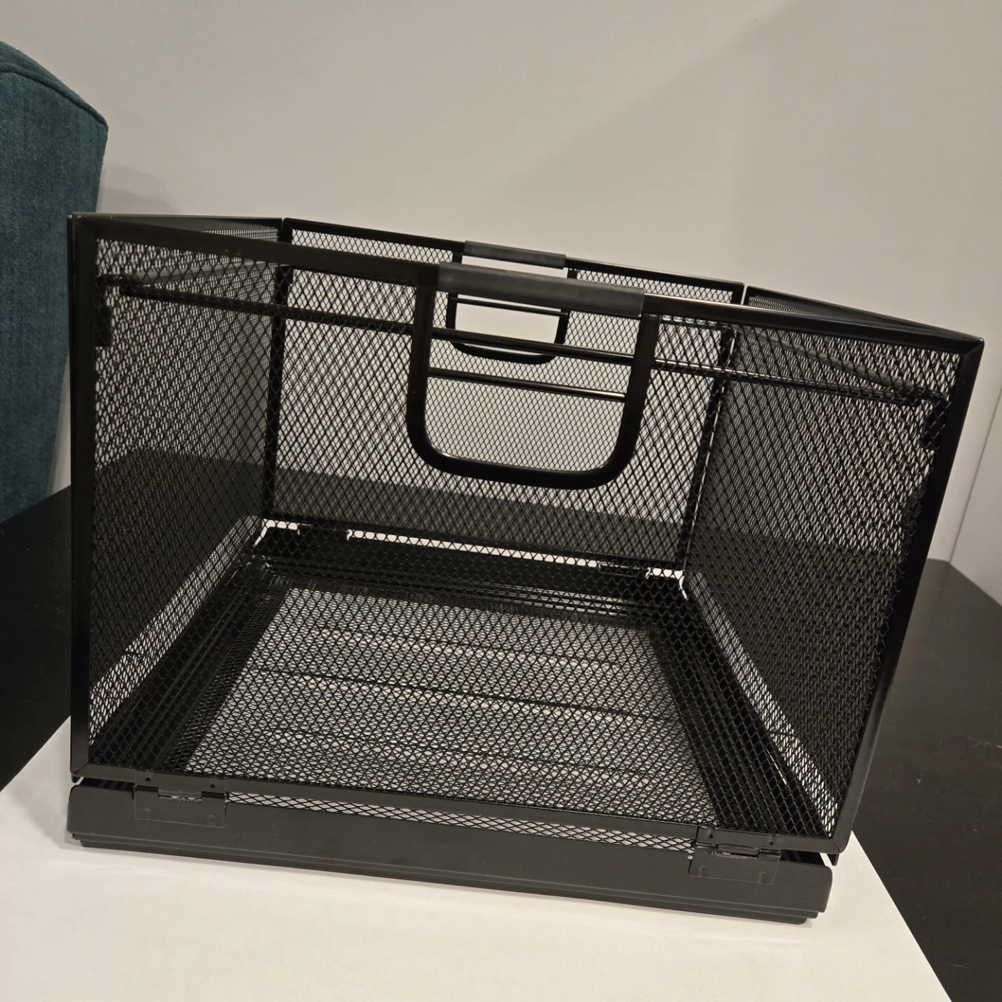 Black metal mesh storage basket