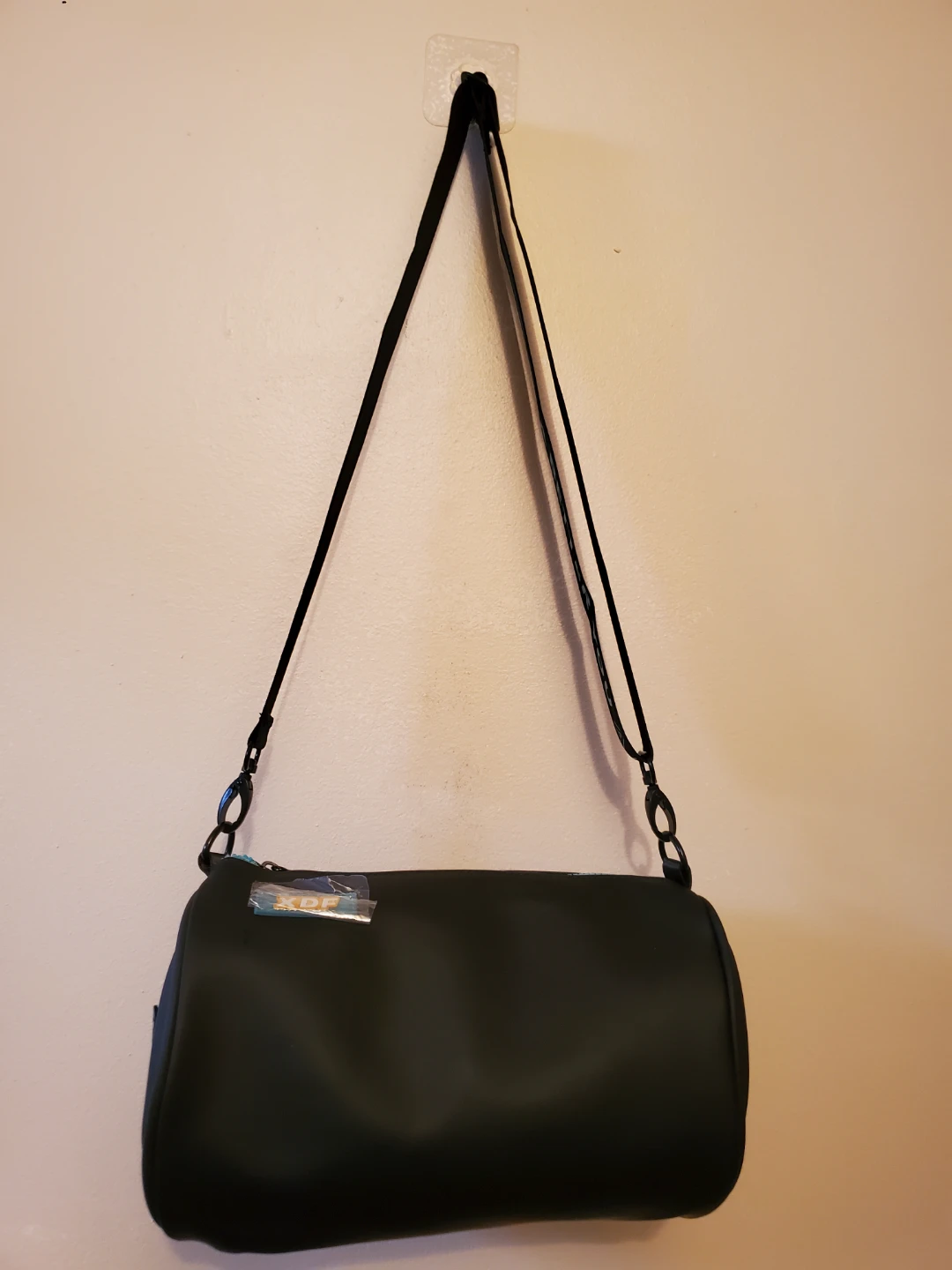 Black barrel bag with blue zipper and "A BETTER YOU A BIGGER"