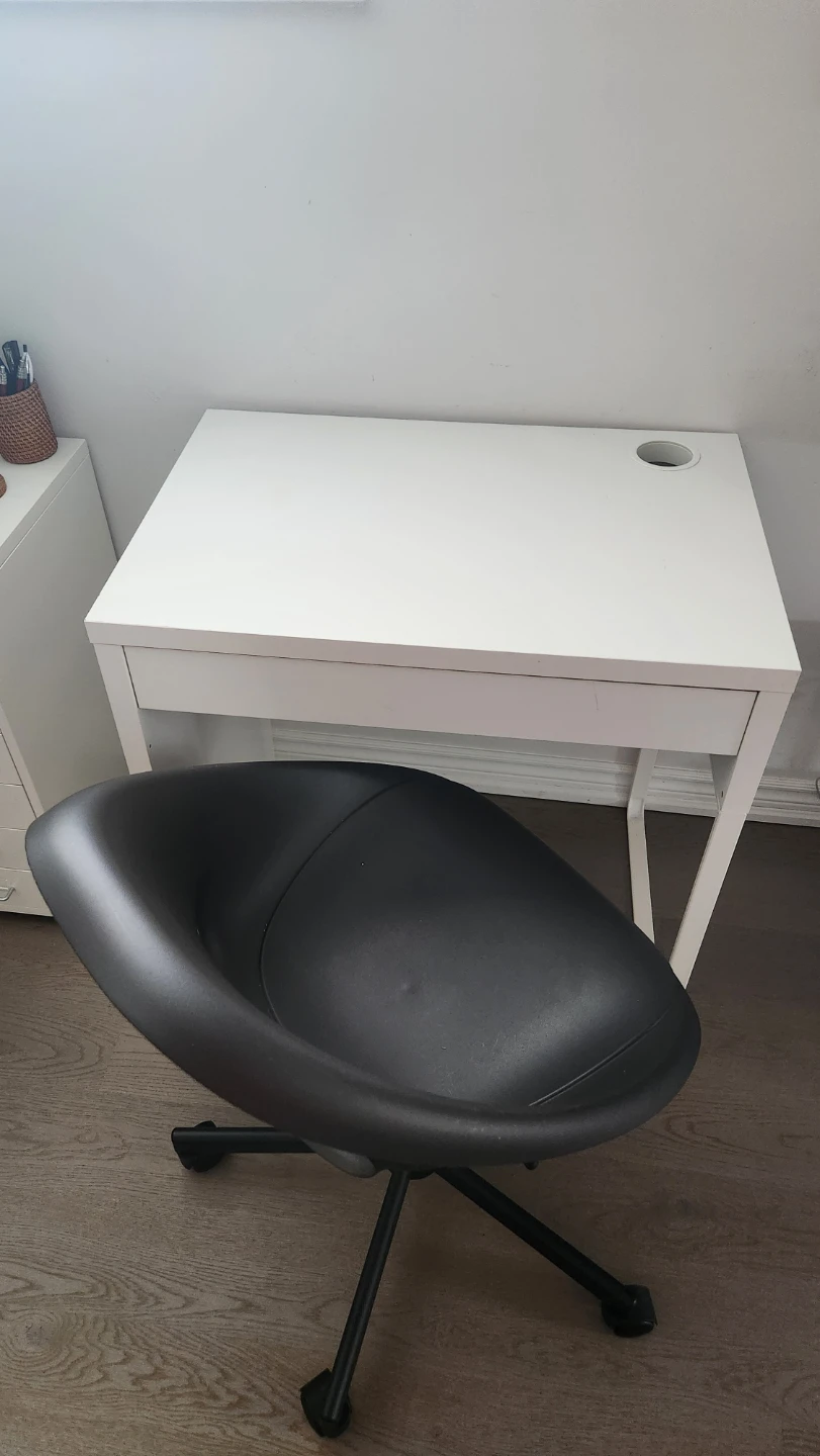 Black Swivel Office Chair and White Desk