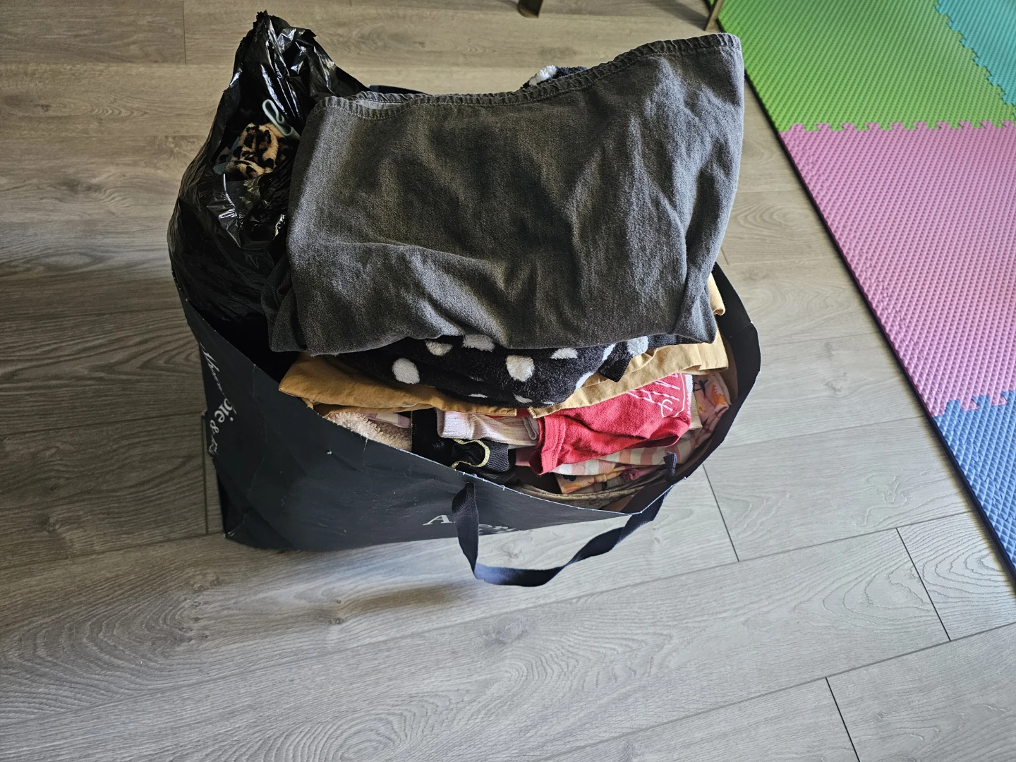 Bag of assorted kids' clothes and adult clothes