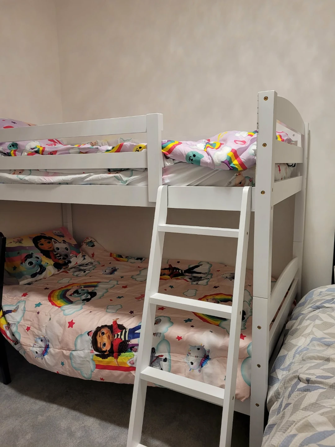 White bunk bed with fun character bedding