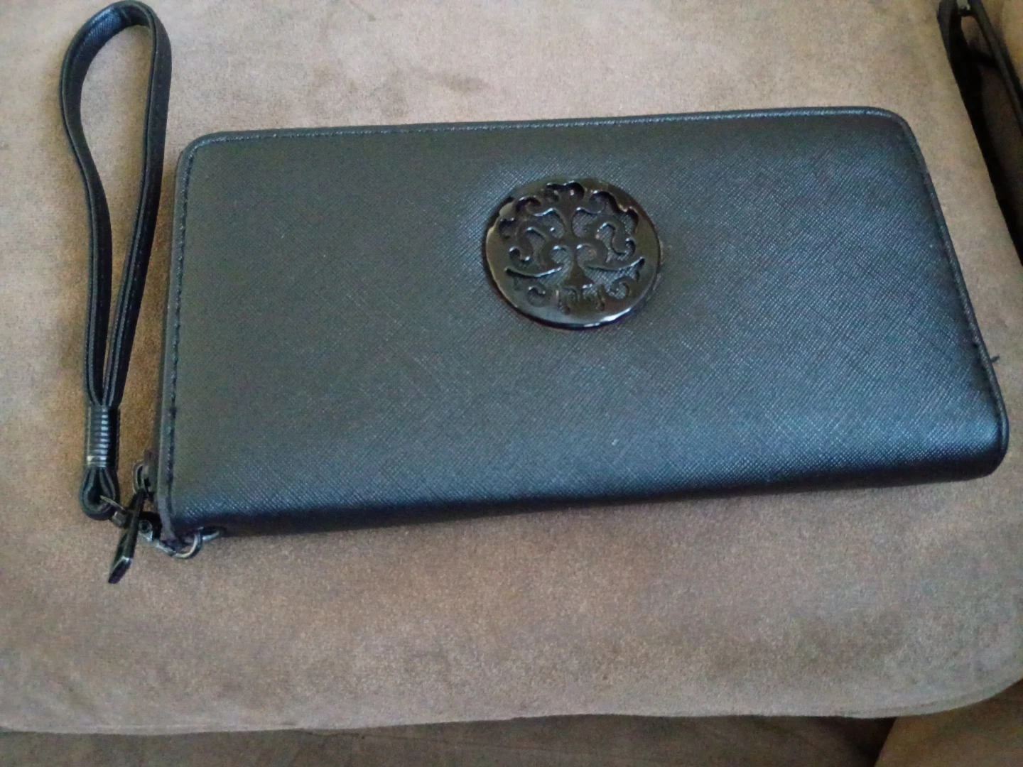 Black zip-around wallet with wrist strap