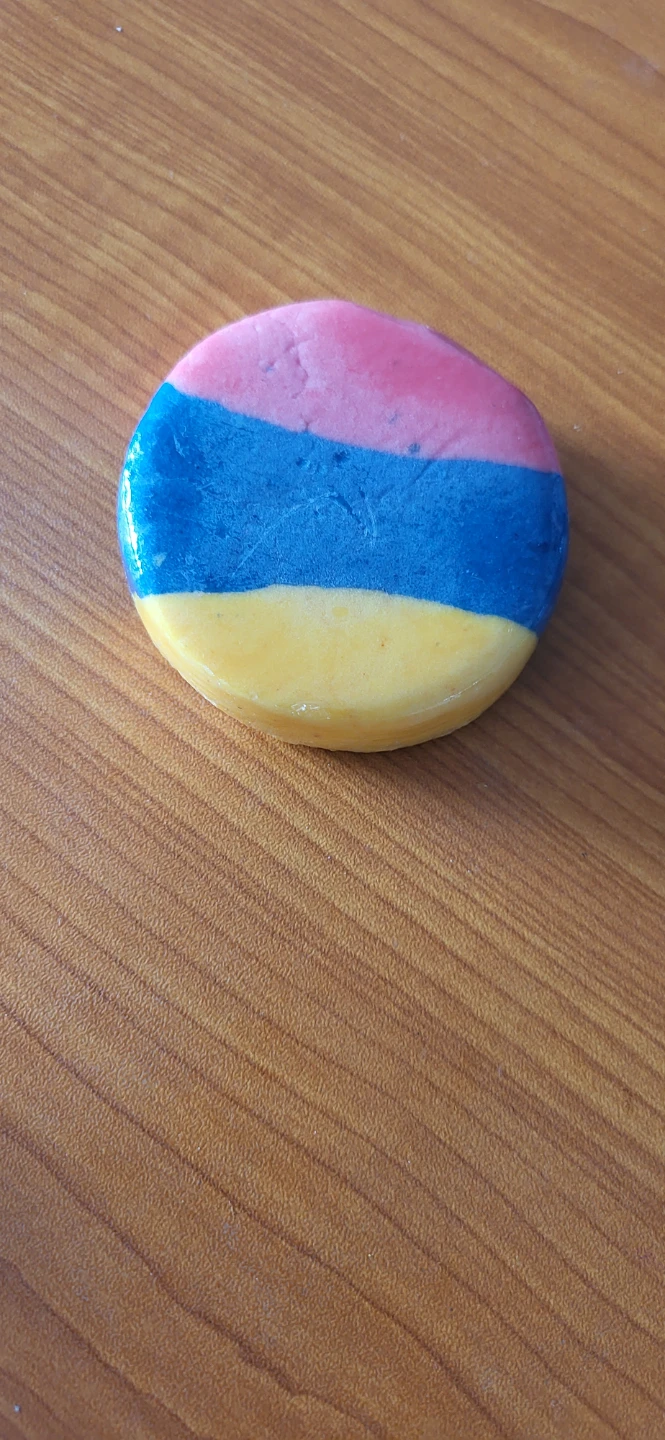Round striped pink, blue, and yellow bath bomb