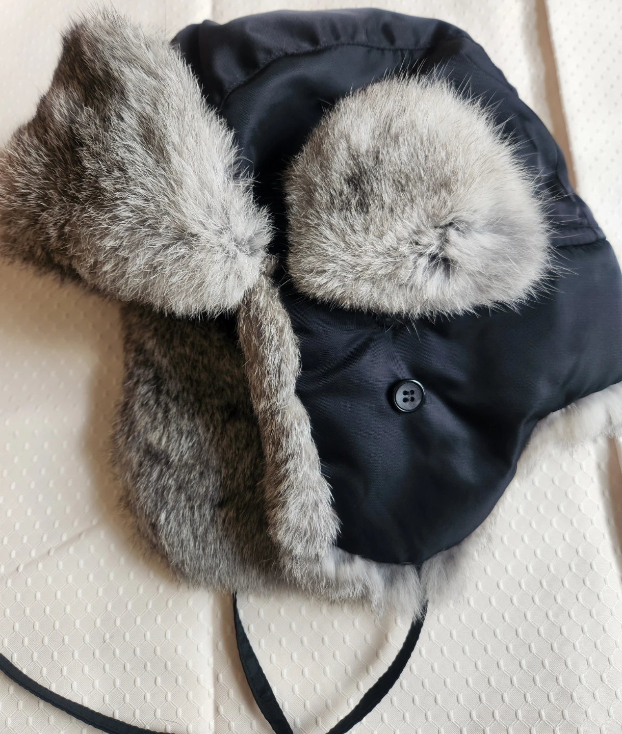 Black Trapper Hat with featuring gray rabbit fur trim