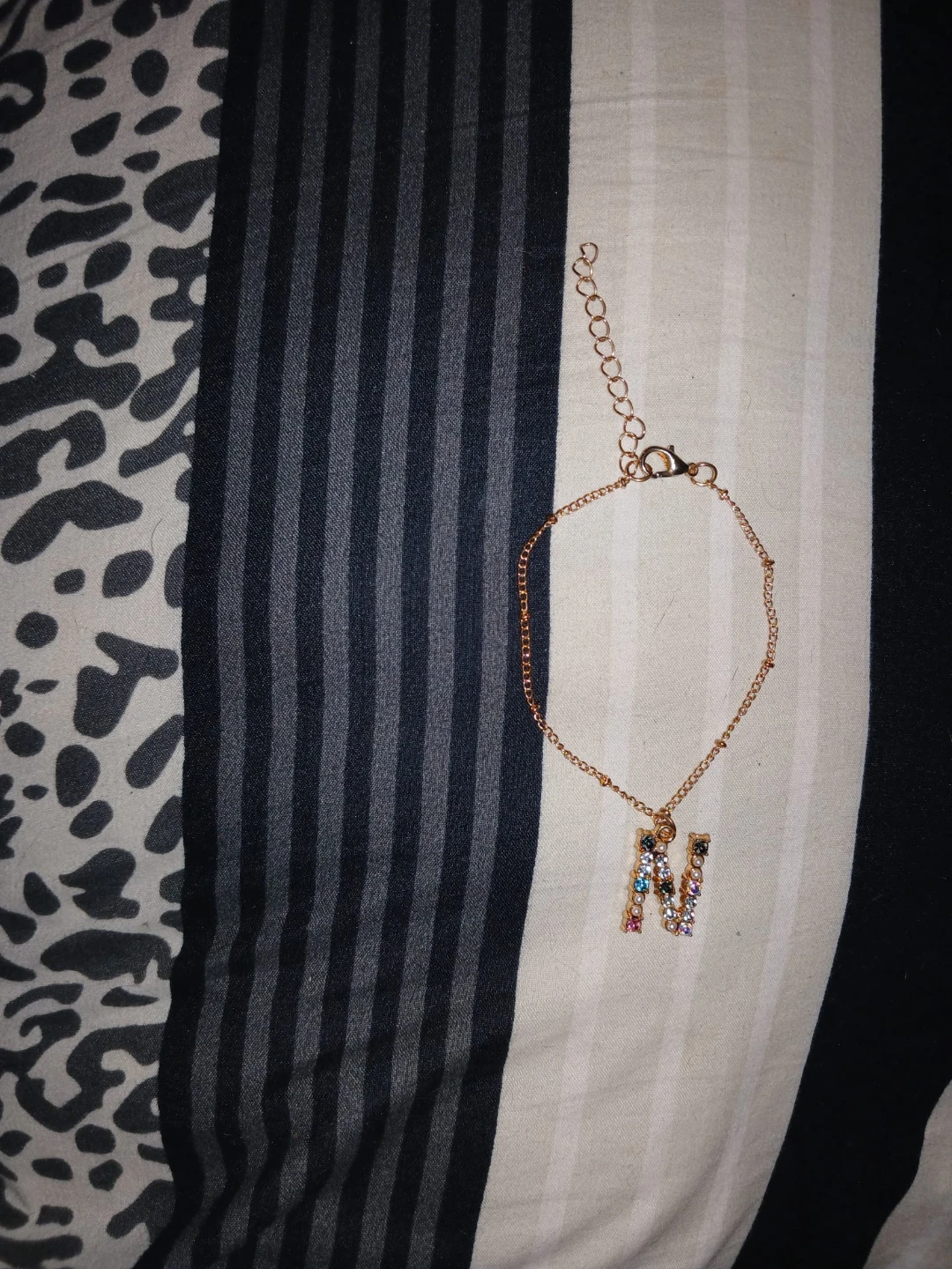 Gold tone bracelet with 'N' initial