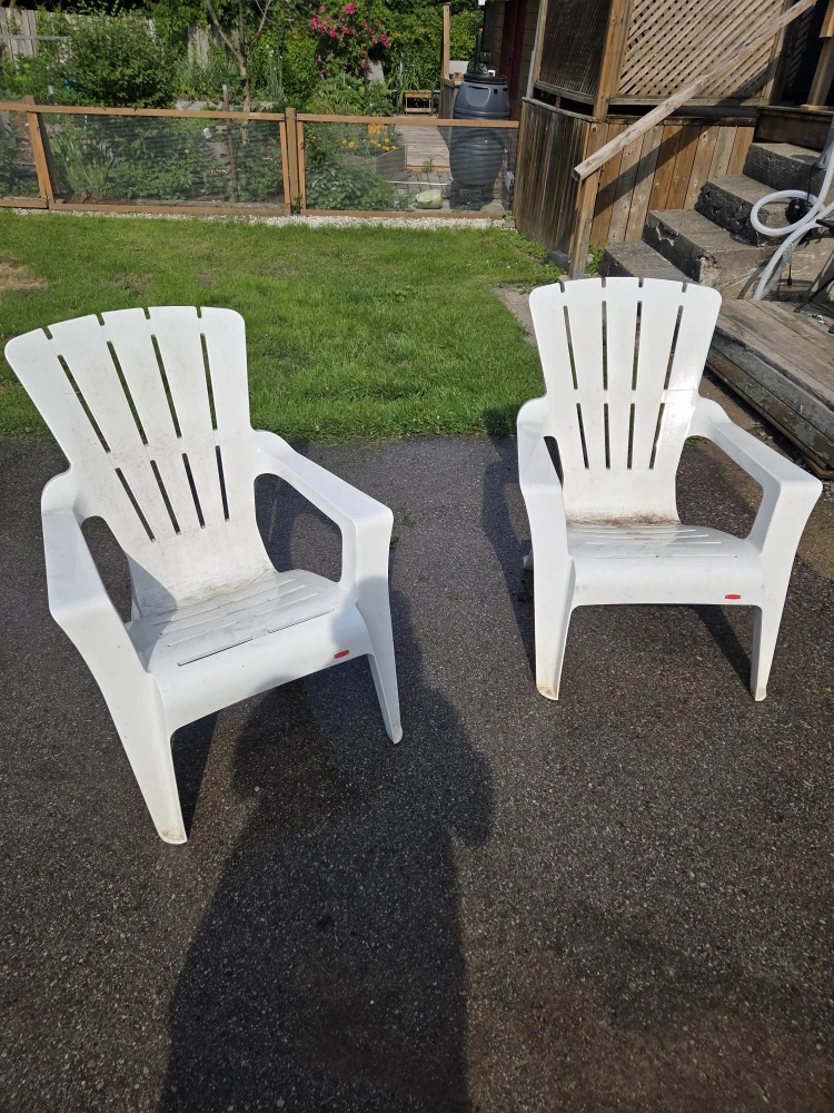 two plastic lawn chairs