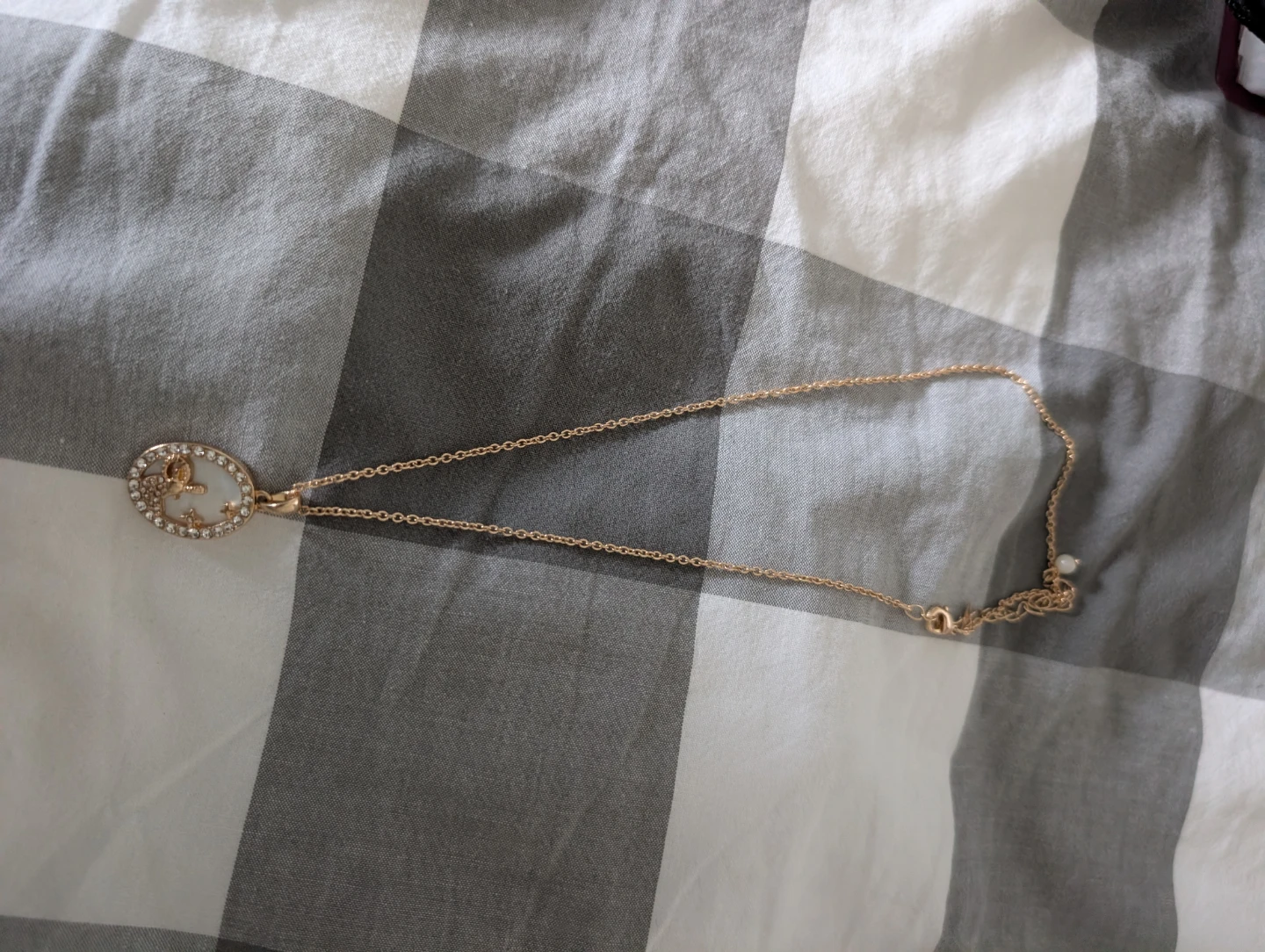 Gold tone oval pendant necklace with rhinestones