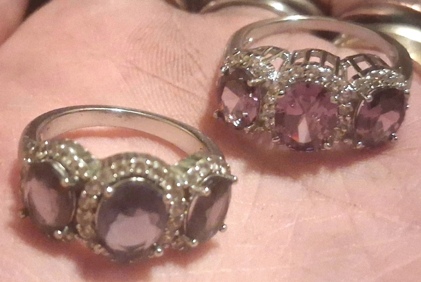 Two silver-tone rings with purple stones