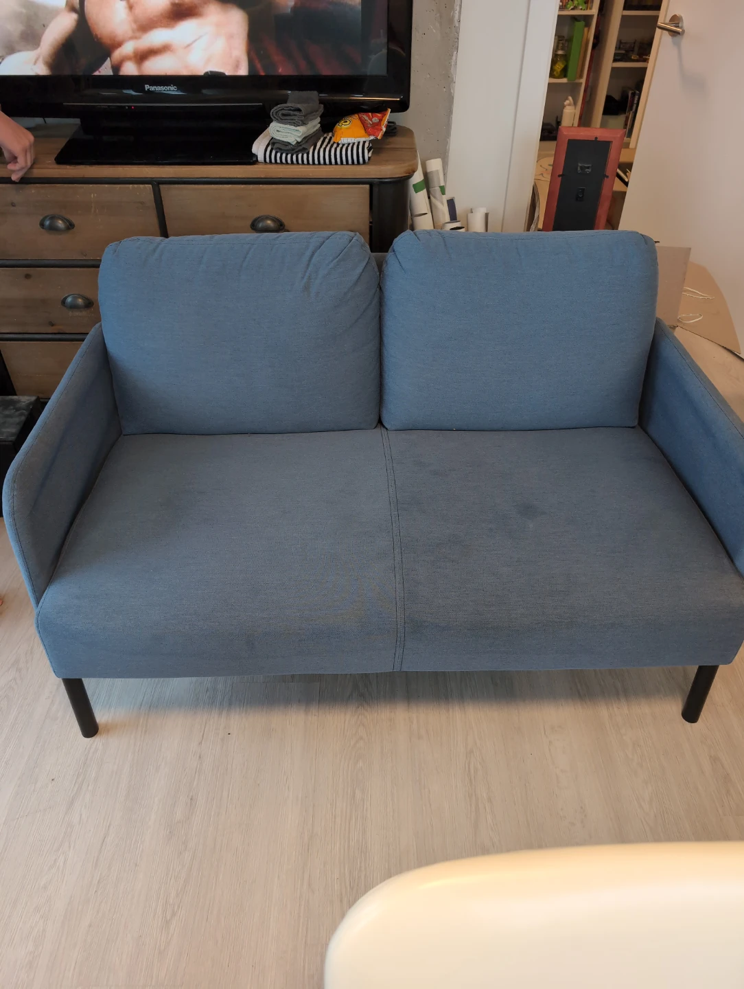 Blue Ikea two-seater sofa