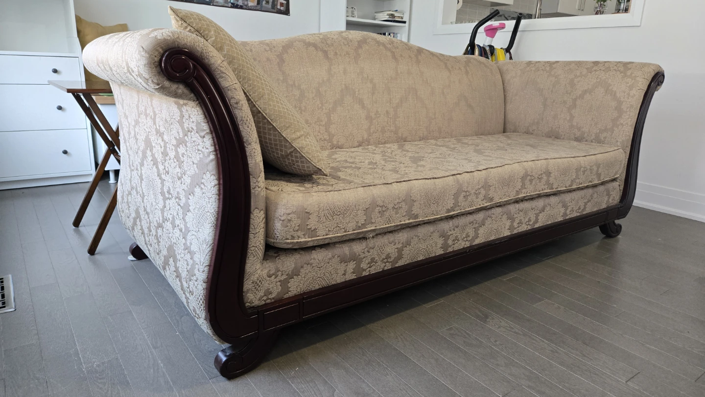 Sofa with patterned upholstery and dark wood trim