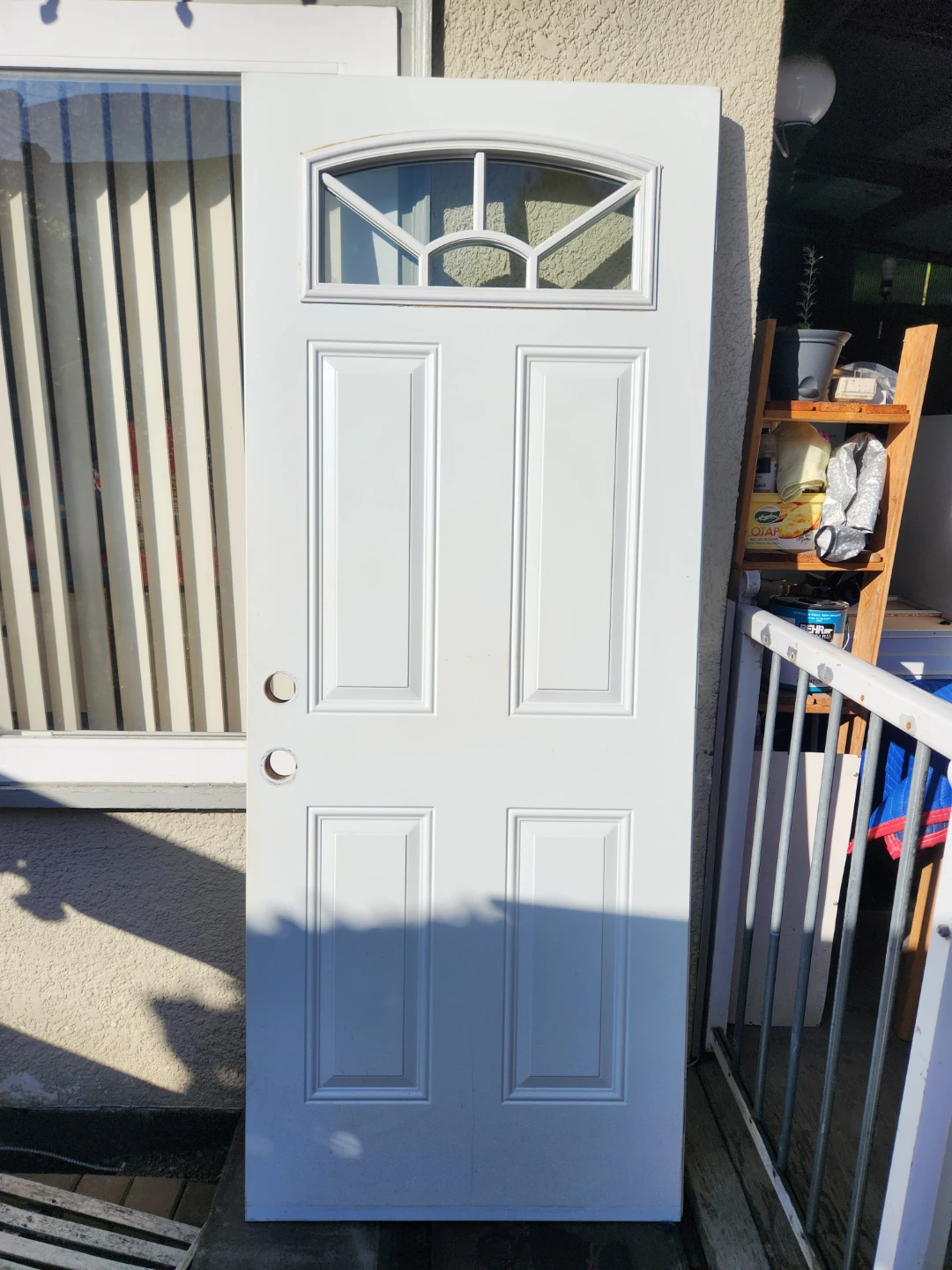 White exterior door with arched window